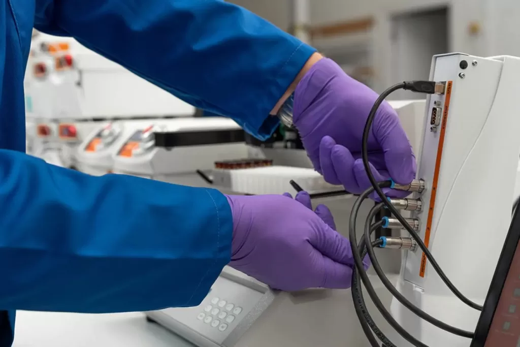 Chemist performing flow electrochemistry synthesis in a lab